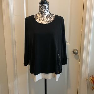 NWOT.  Woman’s long sleeve dressy top with contrast color lining at hemline.
